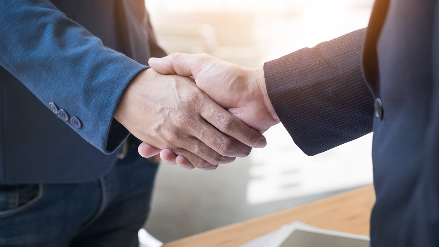 Two Confident Business Man Shaking Hands During A Meeting In The